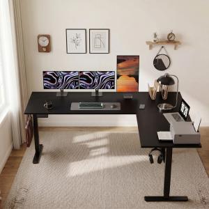 OffiGo 63-inch black L-shaped electric standing desk with multiple monitors, laptop, printer, lamp, and organized corner workspace.