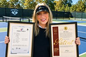 Sheila G. Mains holding U.S. and China patent certificates for VISTO®’s patented transparent-brim hat design at a pickleball court.