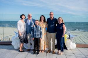 The fourth annual Sunshine Soirée drew a sold-out crowd to the Wychmere Beach Club on the evening of June 4, raising $144,000 for the Sunshine Kids Foundation and carrying the brokerage past a remarkable milestone: more than $1 million raised for the cause since 2018 Sunshine Soiree attendees