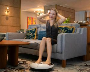 TerraTech, a vanguard in health technology and bio-ergonomics, today announced the international TerraTech Seated Treadmill home wellness device being used by a woman relaxing on a living room sofa
