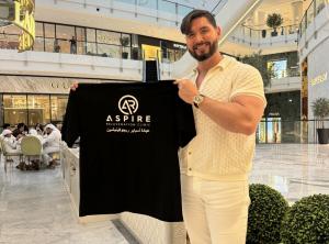 tomo holding shirt in dubai mall