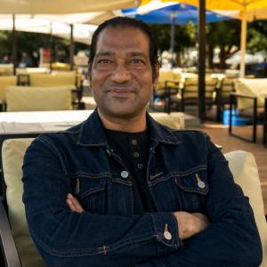 Author Jayanta Bora, writer of THE LYNDOHH CHRONICLES: THE DKHAR, photographed outdoors in a professional portrait highlighting the author behind the literary fiction trilogy.