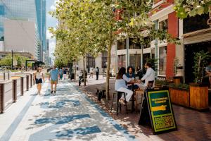 Customers sit in the shade on the Main Street Promenade outside bar Notsuoh