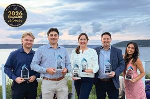 Members of the Massey Remodel + Design team holding six 2026 Remodeling Excellence Awards at the Master Builders Association of Pierce County awards ceremony.