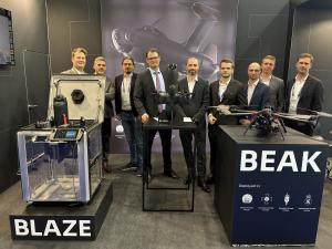 Executives from Alpine Eagle and Origin Robotics sign the Memorandum of Understanding at Eurosatory 2026 in Paris.