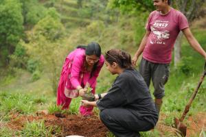 Image shows Prajakta Koli in a field with a woman farmer in Nepal.