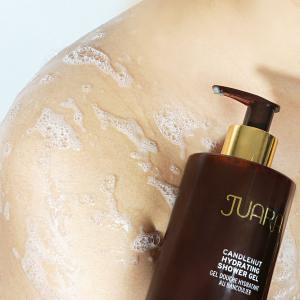 A photo of a woman with foamed up soapy shoulders.