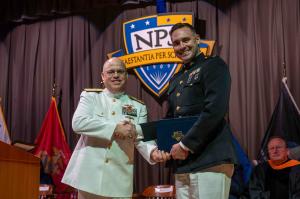 U.S. Marine Corps Maj. Nickolas Mohr is congratulated by U.S. Navy Rear Adm. Michael S. Mattis during graduation from NPS, Mohr is now applying his master's education in AI to develop an enhanced analytics tool for logistics decision-making.