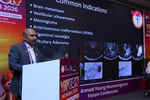 Dr. Mohana Rao Patibandla presenting common indications for stereotactic radiosurgery including brain metastases, vestibular schwannoma, meningioma, AVMs, trigeminal neuralgia, and pituitary adenoma at YNFCON 2026 Mumbai.