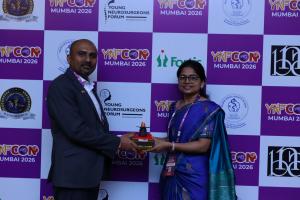 Dr. Mohana Rao Patibandla receiving a memento during YNFCON 2026 Mumbai in recognition of his invited lecture on stereotactic radiosurgery and contributions to minimally invasive neurosurgery.