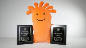 Mr Chili, a cartoon orange coral polyp, is the long standing mascot of Bulk Reef Supply. A large Mr Chili plushie is posed with the two plaques that Bulk Reef Supply was awarded as Best Overall Dry Goods Company and Reefer's Choice, the top honor in the a