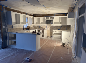 Elite77 Painters demonstrating professional surface protection and cabinet painting preparation for Kansas City residential home improvement projects.