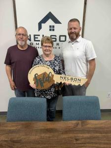 Photo of Joe Nelson and two recent seller clients on closing day for their home.