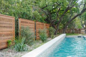 Horizontal cedar privacy fence surrounding a backyard pool with native Texas landscaping, installed by Austex Fence & Deck in Central Texas.