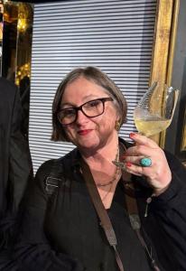 Chef Sophie Brissaud with a glass of white wine