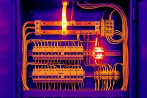 Thermal image of an electrical panel showing heat signatures on electrical components.