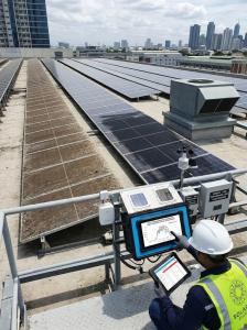 Commercial rooftop solar panels with visible soiling or shading issue.