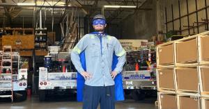 A Vortex Doors Tempe technician wearing superhero cape and eye mask