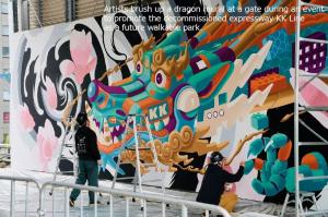 Artists brush up a dragon mural at a gate during an event  to promote the decommissioned expressway KK Line  as a future walkable park.