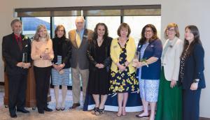 Award recipients standing together and smiling in business attire.  From left to right: Stephen Amico, Susan Rose, Maria Vafiades, Joseph C. Hayes,  Krystin Ruzzano, Jamie Sawtelle, Lisa Santaniello, Nancy Karstunen, Heather Carlisle.