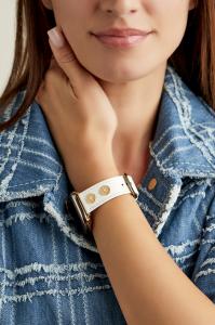 The Denarius in white on model wearing a denim jacket