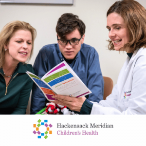 Two healthcare professionals and a young man reviewing a patient navigation booklet together, with Hackensack Meridian Children's Health logo.