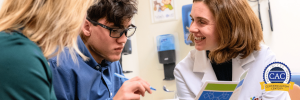 Two healthcare professionals and a young man reviewing a patient navigation booklet together, with CAC logo.