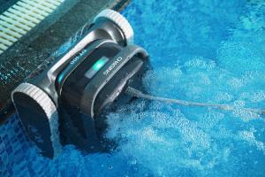 CHASING DT100 corded robotic pool cleaner operating in a commercial swimming pool, connected by cable to provide stable power and support reliable day-to-day pool maintenance.