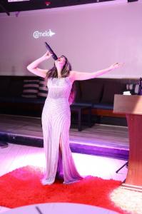 Recording artist Farrah Mechael brought the inaugural Peace Gala audience to its feet with a standing ovation before she and sister, songwriter Tamara Mechael, formally accepted their appointments as Ambassadors for Peace through the Universal Peace Federation which holds ECOSOC status with the United Nations, alongside distinguished leaders from sports, technology, philanthropy, and public service Farrah Mechael performs live on stage in a silver evening gown during the inaugural Peace Gala in Palm Beach, singing before accepting her Ambassador for Peace appointment.
