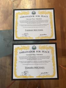 Official Ambassador for Peace certificates awarded to Farrah Mechael and Tamara Mechael by the Universal Peace Federation displayed side by side.