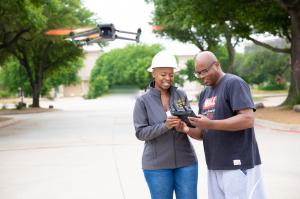 Steffanie Rivers providing hands-on drone flight training to a student during an FAA drone instruction session.