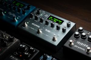 The image shows a Timeline MX multi-delay pedal installed on a professional pedalboard