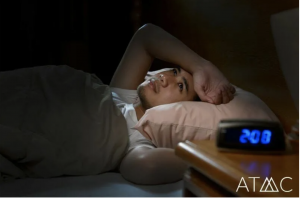 Person lying awake in bed at night representing insomnia during Ambien withdrawal.