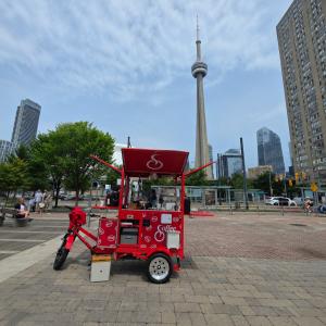 Red Coffee Bike espresso bar set up near Toronto's CN Tower during THE CROSSING – Canada and USA documentary journey across North America.