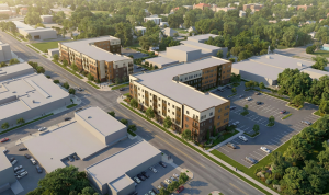 Architectural rendering of Linwood & Troost Apartments, a proposed 100% affordable housing development by Milhaus at 3200 Troost Ave. in Kansas City, Missouri, featuring two four-story residential buildings at the corner of Linwood Boulevard and Troost Av