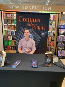 Photo of Gene Duffy at a book signing for “Conquer the Planet: A Modern-Day Global Enslavement Handbook,” written under the pseudonym Sir Lawrence McAlister