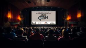 Image of a large audience in a theater venue where a Better Together Film Festival Screening event will be held. The screen in the theater is displaying an openning image welcoming the audience to the event, displaying the film festival logo and title.