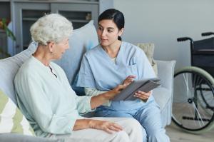 elderly caucasian woman speaking to physical therapist