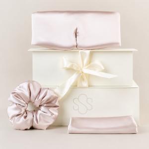 Blush-pink silk scrunchie and matching accessories arranged with cream SENSOIRE gift boxes.