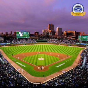 Evening aerial view of a packed stadium and baseball game in progress.