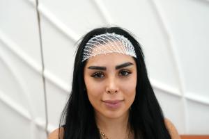 A patient receives guidance on eyebrow transplant recovery during a private consultation.