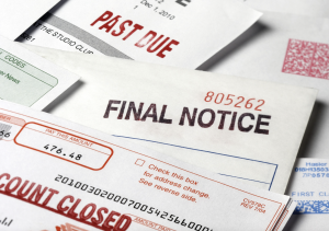 Construction project managers reviewing unpaid invoices and accounts receivable for commercial construction debt recovery.