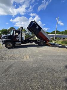 Gentry Dumpster Rentals roll-off dumpster delivering landscaping material near Denison TX