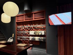 MUSASHI JAPAN Kyoto store display area with Japanese kitchen knives, paper lanterns, and an in-store video screen.