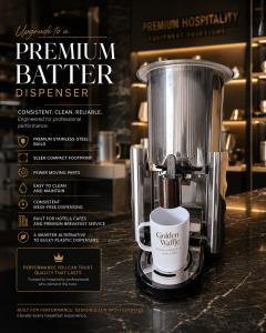 Golden Waffle premium stainless-steel batter dispenser with branded cup in a luxury hospitality setting, designed for clean, consistent and reliable service in hotels, cafés and professional breakfast areas.