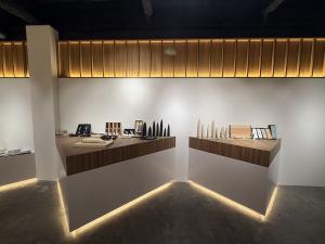 Japanese kitchen knives displayed on wooden counters inside MUSASHI JAPAN Hiroshima Hondori Store