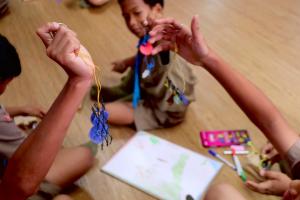 Students at Ban Kalim School making recycled keychains during Hyatt Regency Phuket Resort's marine conservation workshop.