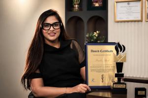 Prachi Shah, Director & Chief Financial Officer of Valasys Media, posing with her Business Elite 40 Under 40: 2026 New York Edition award trophy and recognition certificate.