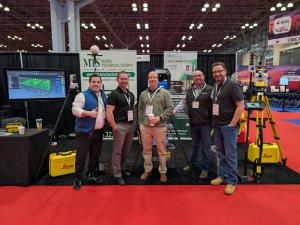 Members of the Maine Technical Source and Mechasys teams assemble at their joint booth, featuring the Mechasys laser layout tool.