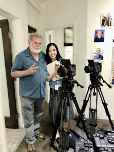 Jieying “Jenny” Liu has spent much of her career at the place where filmmaking becomes most human: between a creative vision and the people required to carry it into reality Jieying “Jenny” Liu standing with cinematographer Dean Cundey beside professional film cameras at The Lot Studios in Hollywood.
